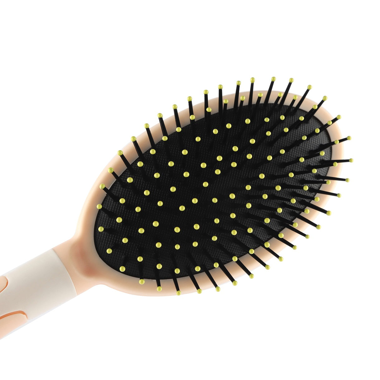 Close-up of black bristles – angled view of hair brush head with yellow tips.